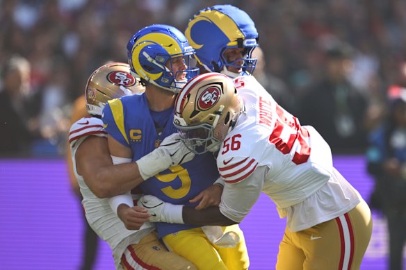 Rams quarterback Matthew Stafford is tackled after making a pass on Friday.