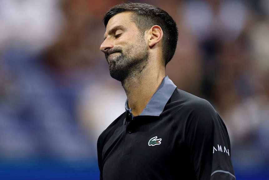 Novak Djokovic reacts during a match looking like he should have hit the shot
