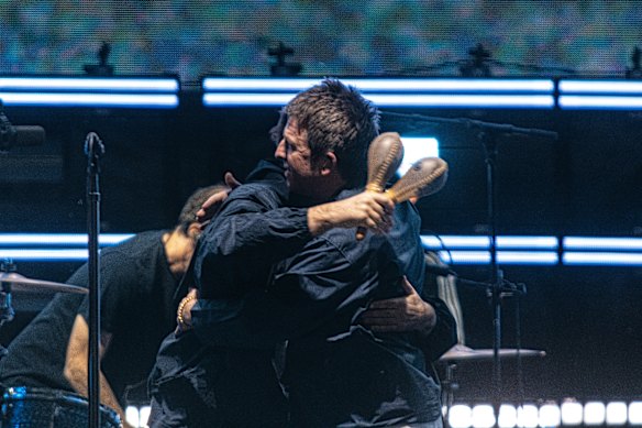 Feud? What feud? Liam and Noel Gallagher embrace on stage during the Melbourne leg of their reunion tour last year.