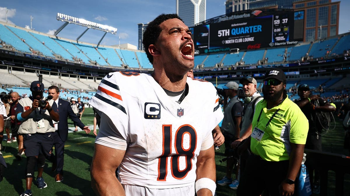Caleb Williams celebrates on the field after the Chicago Bears' win.