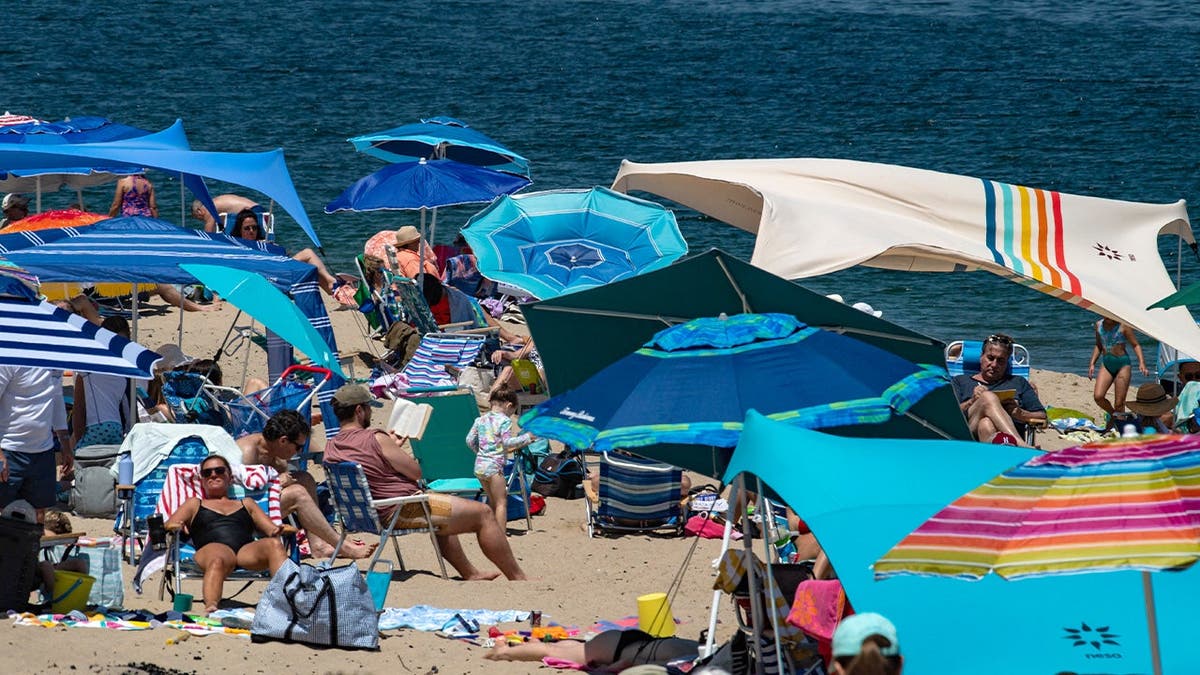 People lounge on a Cape Cod beach.