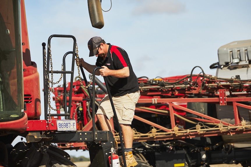 A farmer climbs into a header.