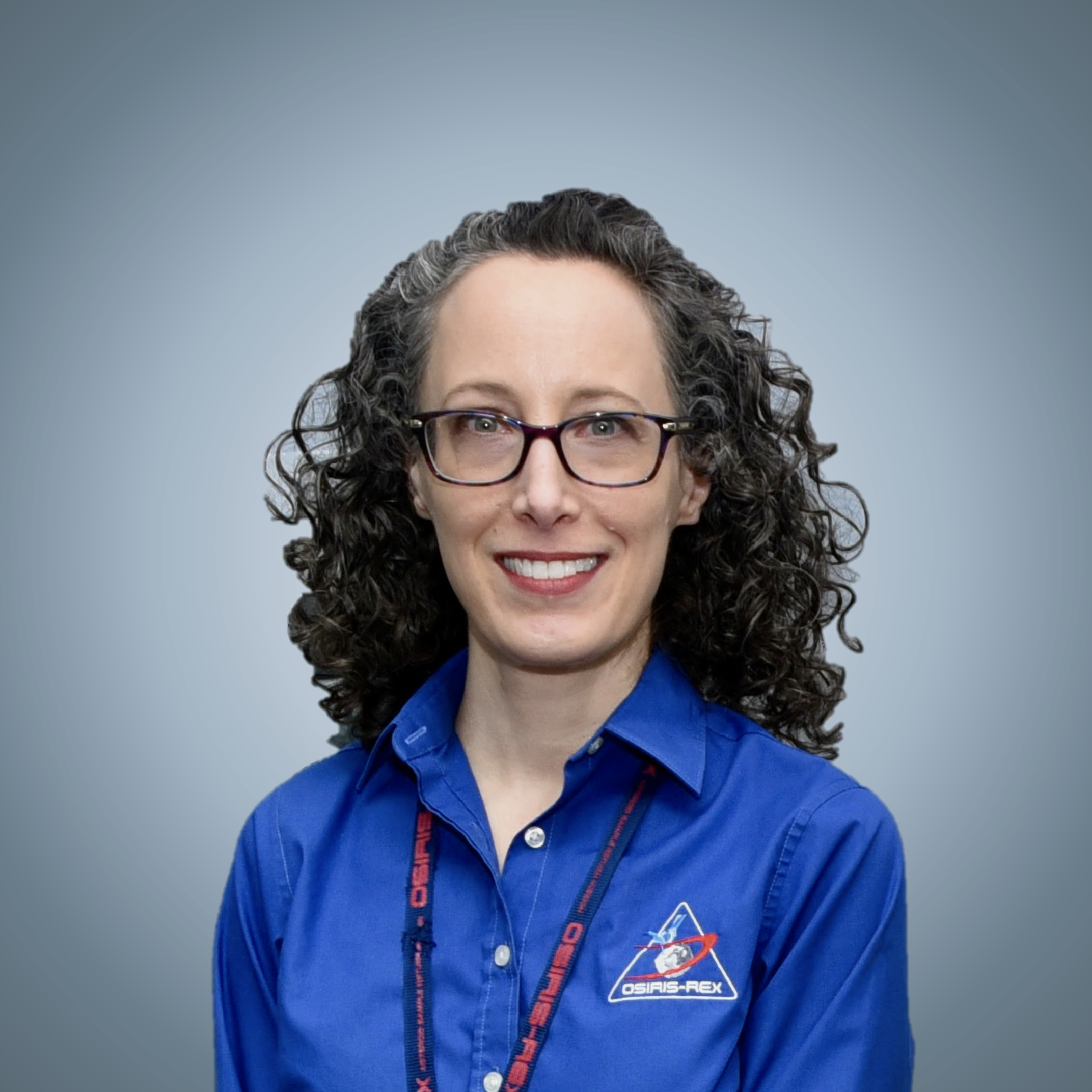 A headshot of Amy Simon in a blue NASA uniform 