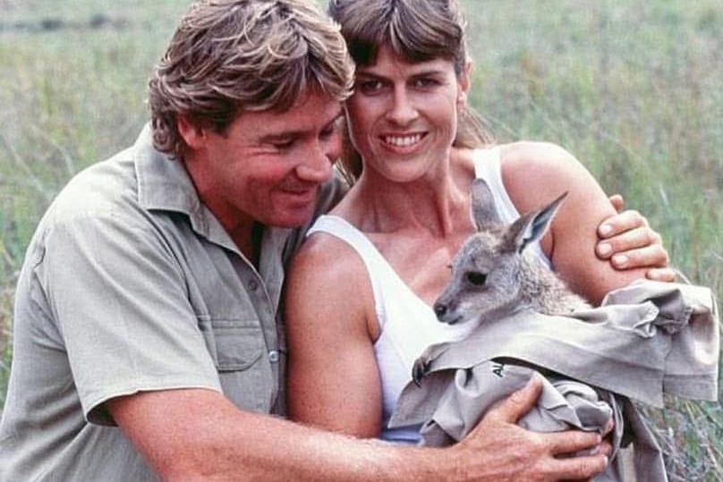 Man and woman with kangaroo in field