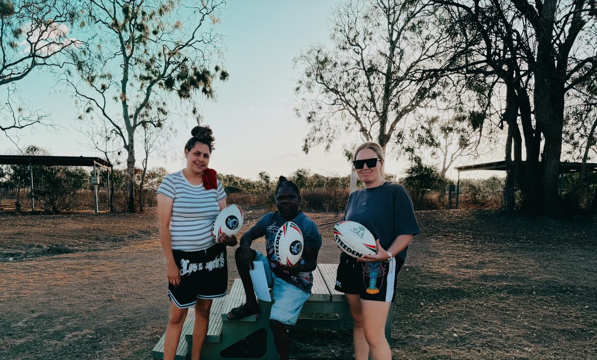 three women with rugby league balls