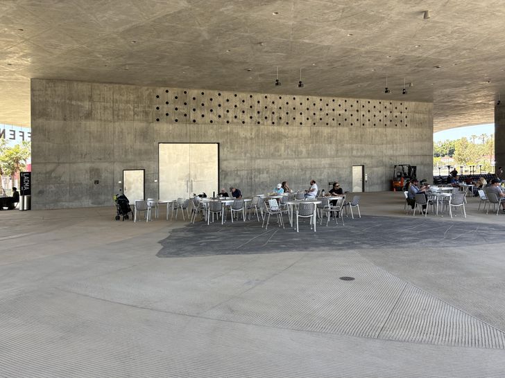 People seated in the David Geffen Galleries entrance.