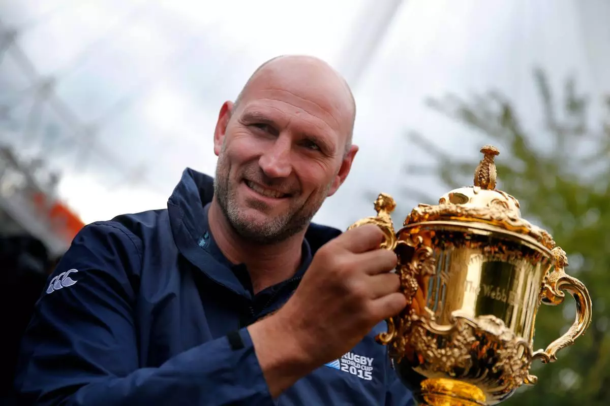 FILE - England Rugby 2015 ambassador Lawrence Dallaglio poses for photographs with the Webb Ellis Cup, in London, Tuesday, Sept. 15, 2015. (AP Photo/Christophe Ena, File)