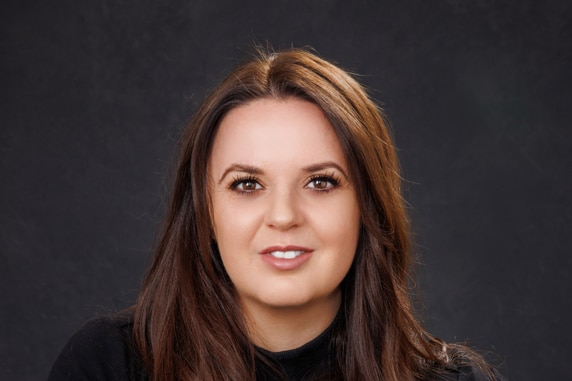 A profile picture of a woman with brown hair