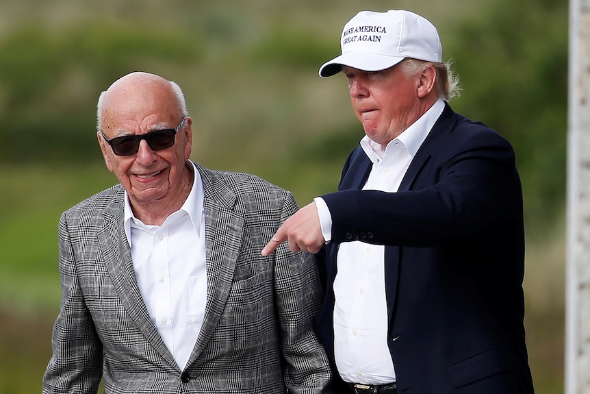 Rupert Murdoch and Donald Trump on a golf course.