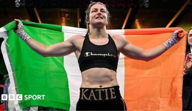 Katie Taylor holds the Ireland flag over her shoulders