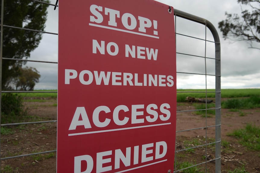 A red sign says Stop! No New Powerlines. Access Denied.