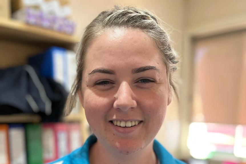 Molly Ticehurst in her blue work uniform at Forbes Learning Ladder.