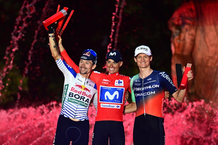 Primož Roglič, Enric Mas and Felix Gall hug