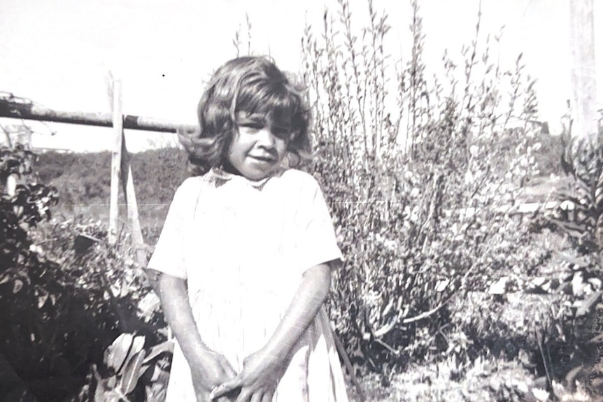 A black and white photo of a young girl