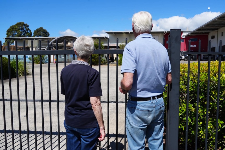 shot behind couple at gate