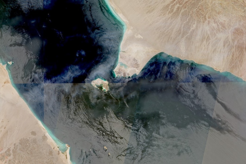 A satellite image showing a narrow strait of water between two continents.