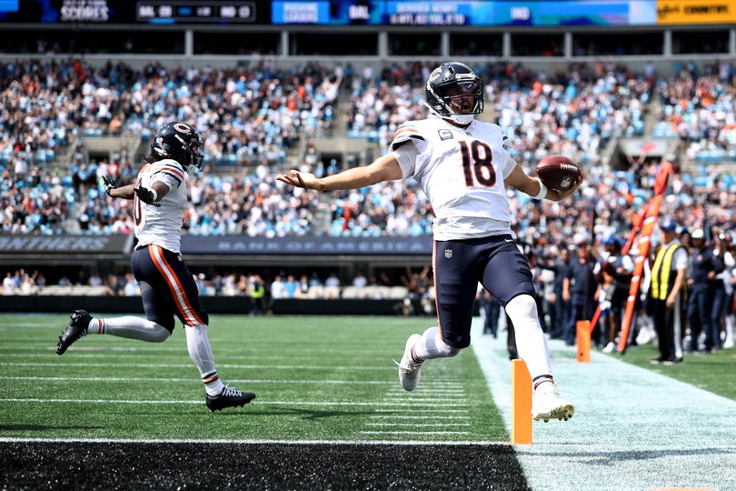 Caleb Williams #18 of the Chicago Bears celebrates after scoring a touchdown.