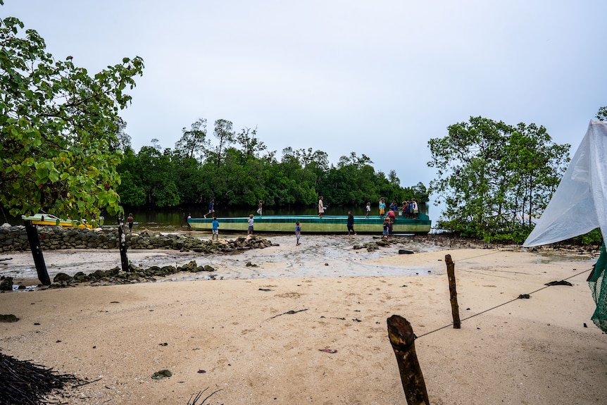 A narco-sub on the sand at low tide.