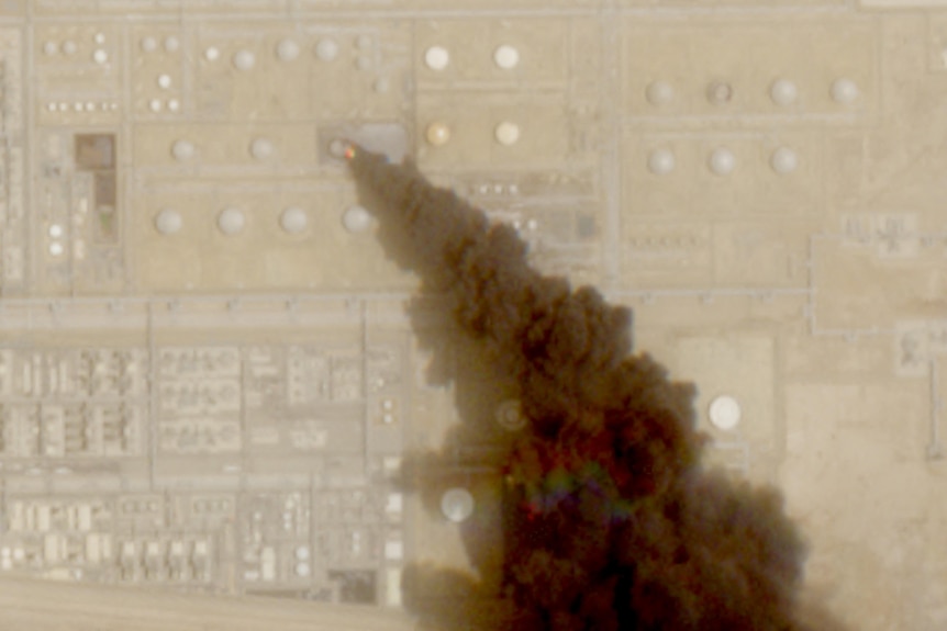 A satellite image shows trail of smoke rising from an oil facility, in Jizan in Saudi Arabia.