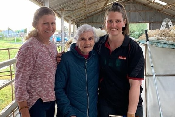 Three generations of women, Helen, Ruth and Nicki Guttler, standing together in a shearing shed.