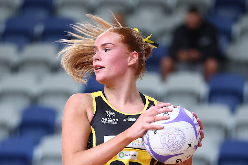Netballer Scarlet Jauncey has the ball and is looking to pass
