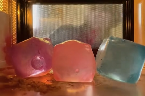 Three squishy cubes inside a microwave.