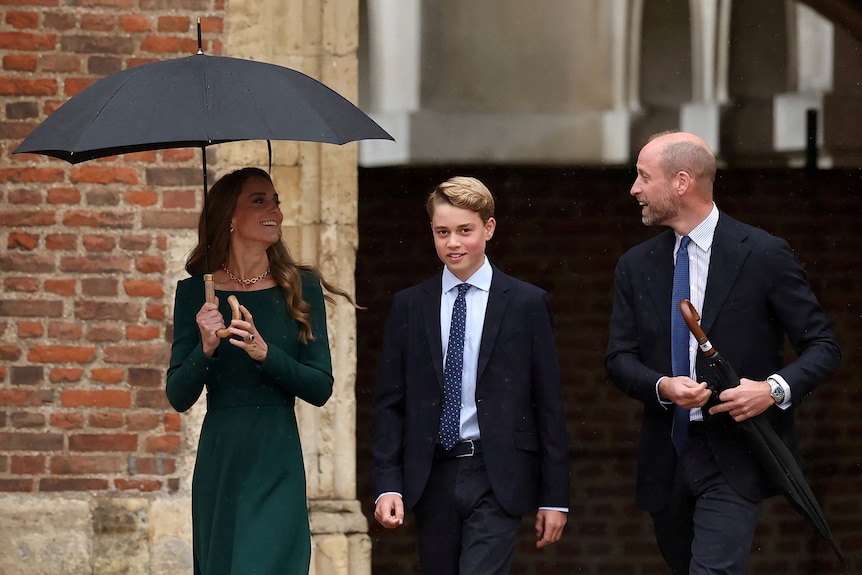 Princess Catherine, Prince George, Prince William walk together, smiling.