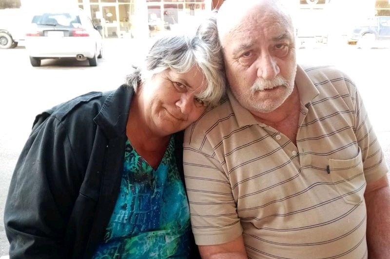 a woman and man sitting side by side