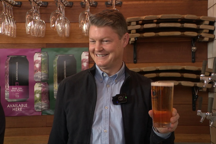 Ben Carroll holding a beer.