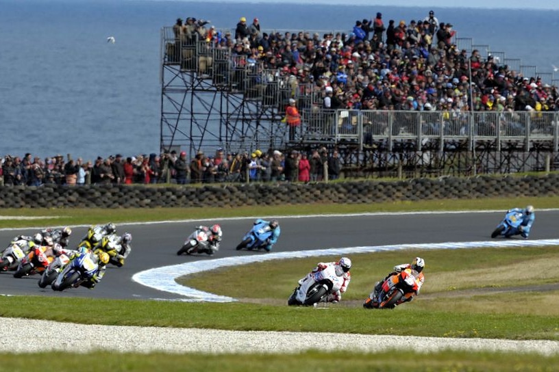 Dani Pedrosa leads Casey Stoner and the rest of the field on the opening lap