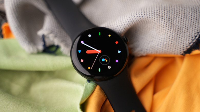 A Google Pixel Watch against a fabric background