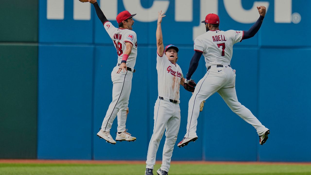 Cleveland Guardians left fielder Steven Kwan, left, center fielder Petey Halpin, center, and right fielder Jo Adell (7) celebrate after the Guardians defeated the Chicago White Sox in a baseball game in Cleveland, Wednesday, Sept. 16, 2026. (AP Photo/Sue Ogrocki)