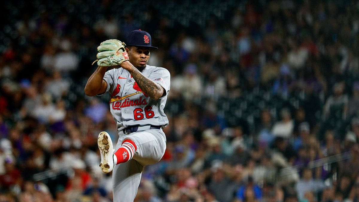 Hancel Rincon, wearing St. Louis Cardinals uniform number 66, pitches during the sixth inning at Coors Field.