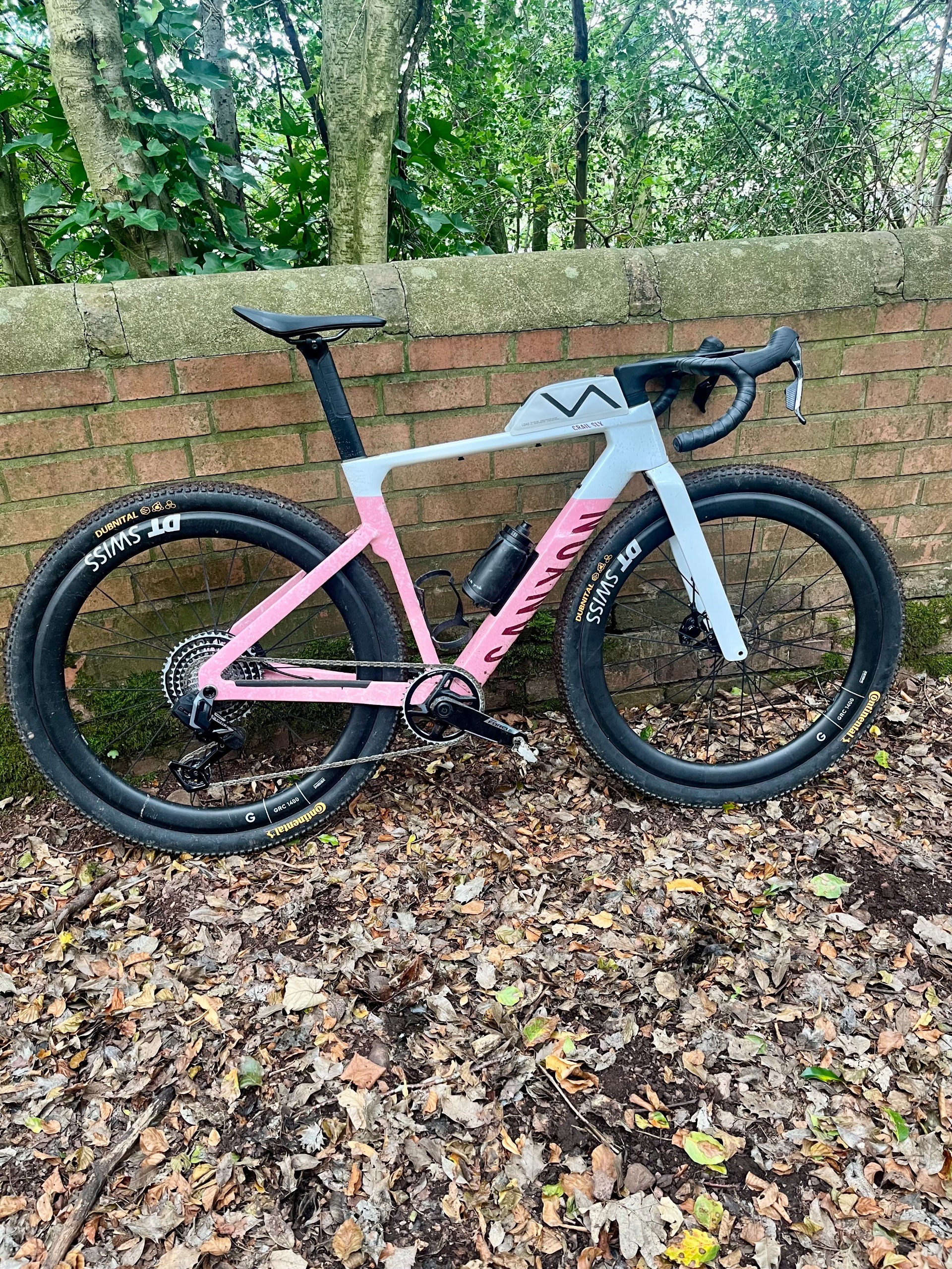 A pink and white Canyon Grail CF SLX fitted with Continental Dunital tyres