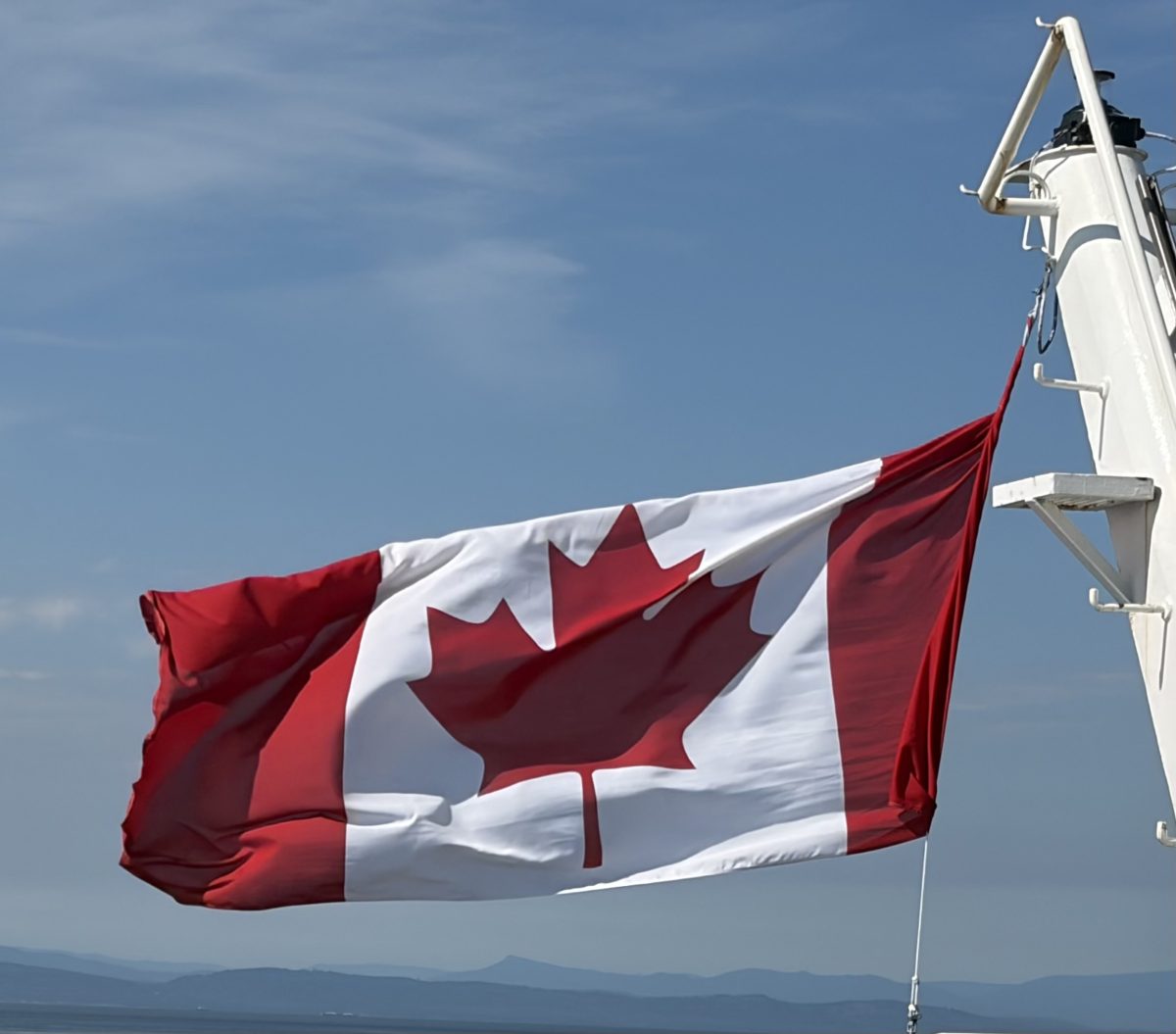 Canadian flag against blue sky