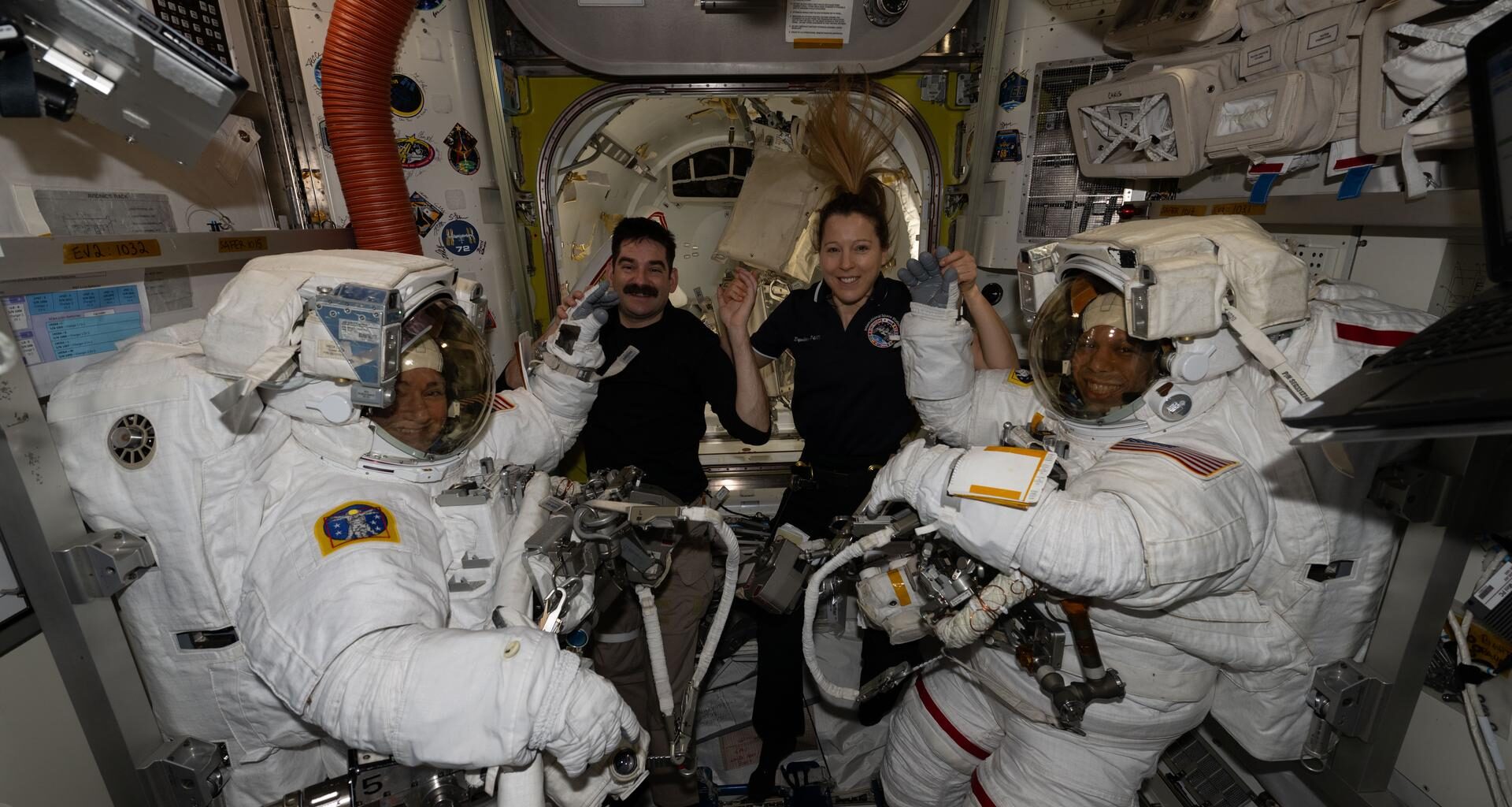 At center, Expedition 74 flight engineers Jack Hathaway of NASA and Sophie Adenot of ESA (European Space Agency) pose for a portrait with NASA flight engineers Jessica Meir (far left) and Chris Williams (far right) after assisting the pair into their spacesuits inside the International Space Station’s Quest airlock. Shortly afterward, Meir and Williams exited Quest to begin a seven‑hour‑and‑20‑minute spacewalk to replace a malfunctioning wrist joint on the Canadarm2 robotic arm.