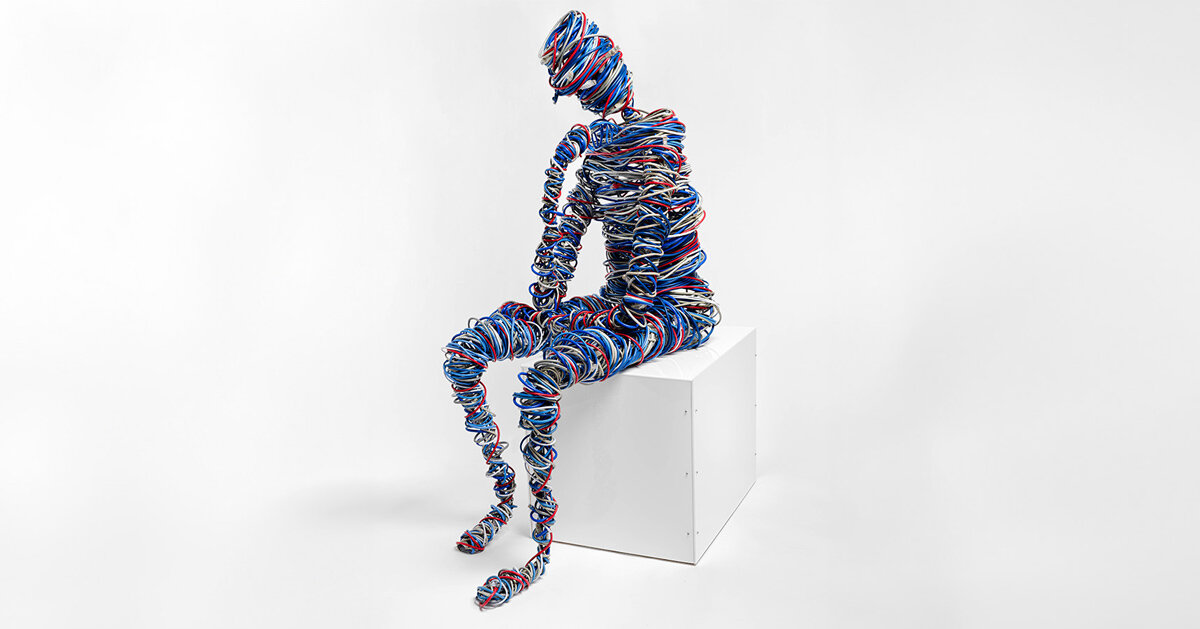 hundreds of feet of network cable and steel reimagine rodin’s thinker