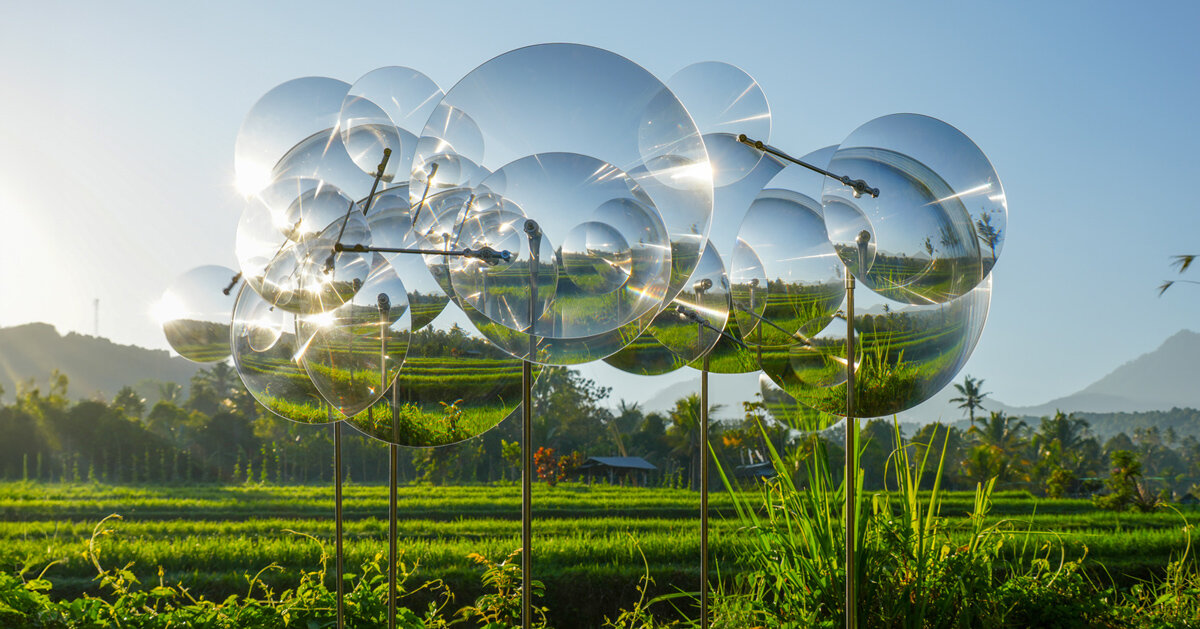 kinetic constellation of fresnel lenses by vincent leroy distorts bali’s landscape