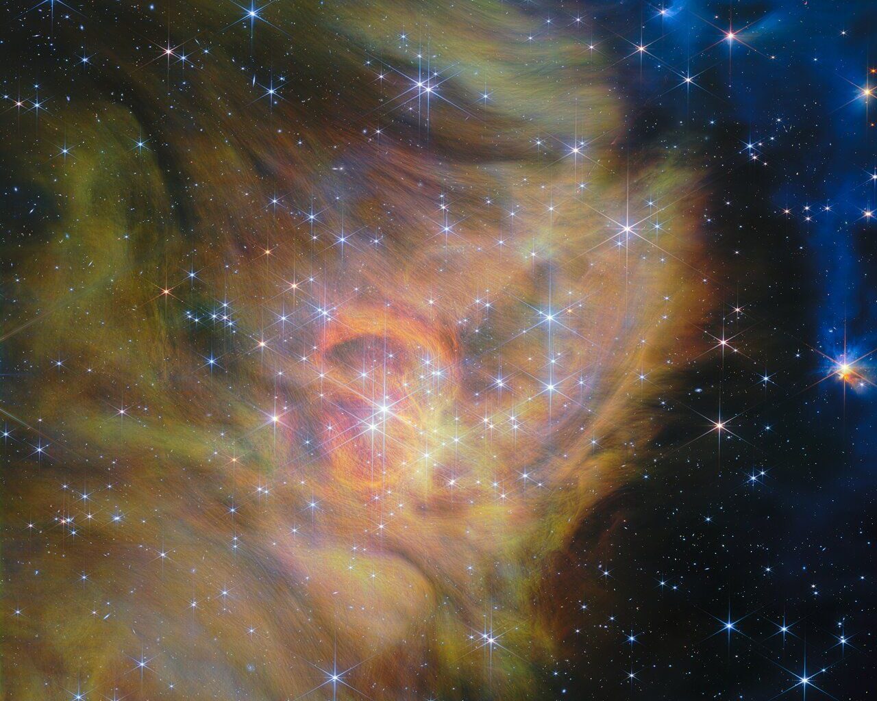 A swirling landscape of dust and dwarf stars in one of the largest JWST photos ever released