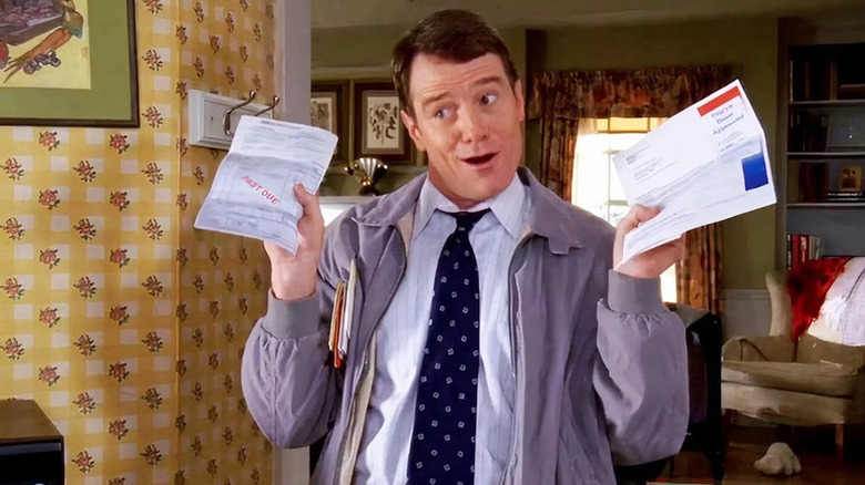 Hal holds up some bills in 