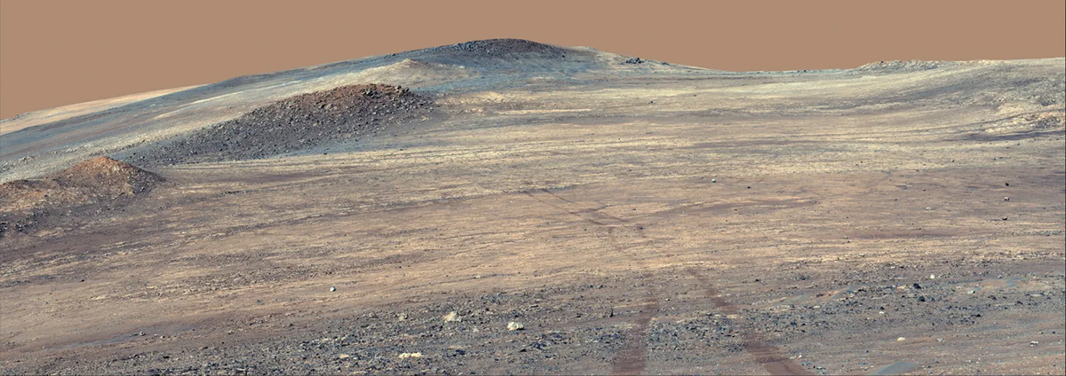 NASA’s Perseverance rover captured this image showing its own tracks descending from the rim of Jezero Crater. Credit: NASA/JPL-Caltech/ASU/MSSS