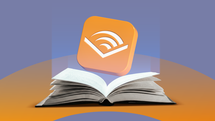 Open book with the Audible logo floating above it.