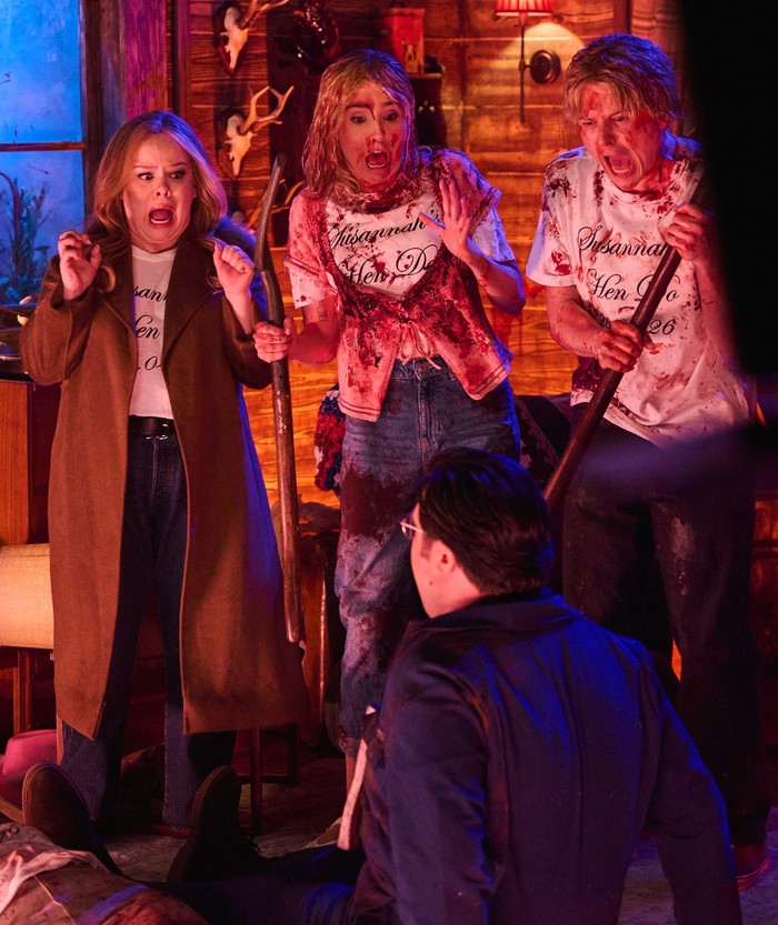 Nicola Coughlan, Annabel Marlow, Jack Shep and Al Nash on SNL UK Nicola Coughlan, Annabel Marlow and Jack Shep in a log cabin setting for an SNL sketch, the latter two covered in blood and brandishing weapons, all screaming. Al Nash in character is sitting on the floor.