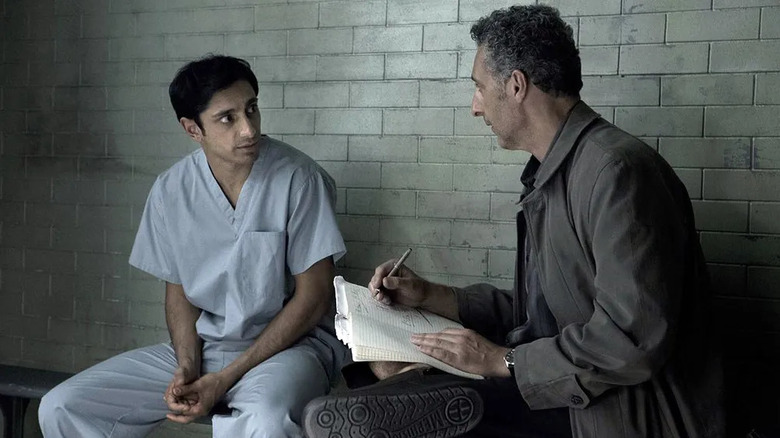 Nasir (Riz Ahmed) and John (John Turturro) sitting in a cell on 