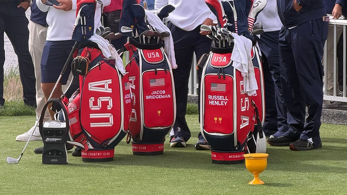 USA golf bags for Jacob Bridgeman and Russell Henley on the practice area at Medinah Country Club.