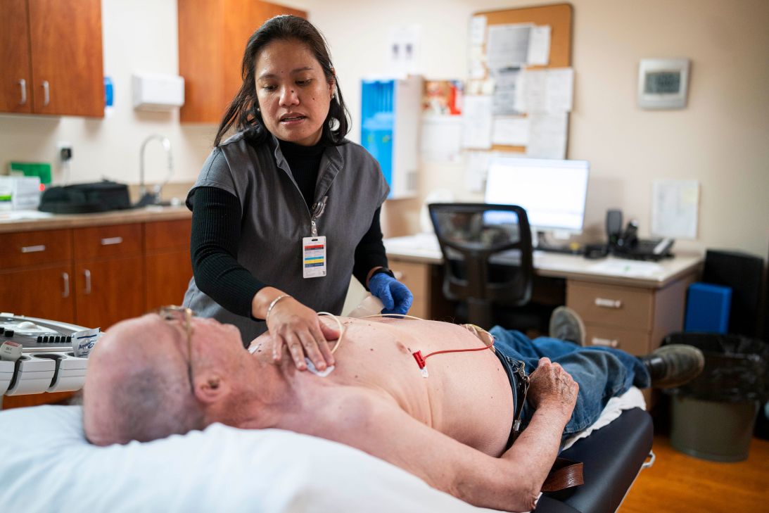 Marichu Castillo Villamiel prepares a patient for tests inside West River Hospital, a rural facility that serves people from three different states.
