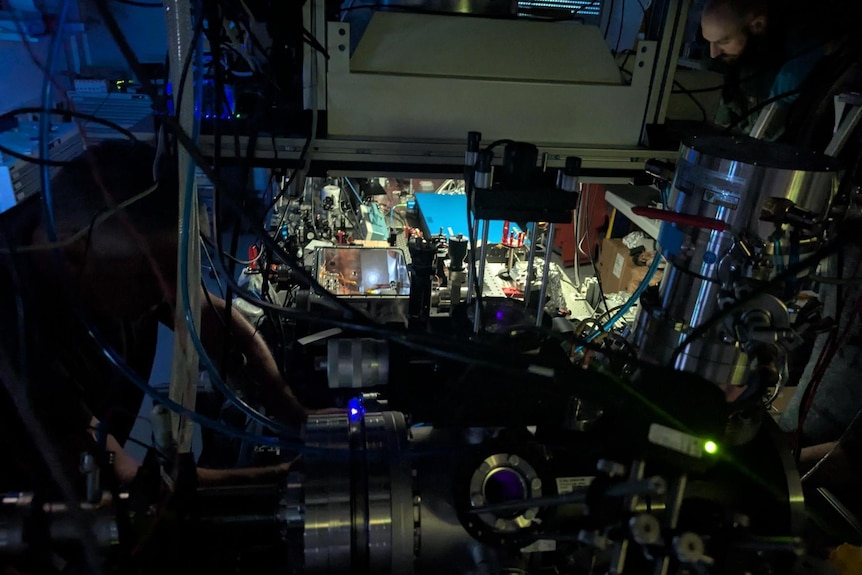 Dark lab filled with complicated technology.