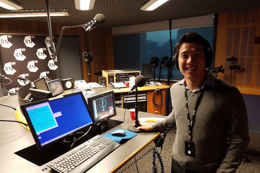 David in RN studio, wearing headphones