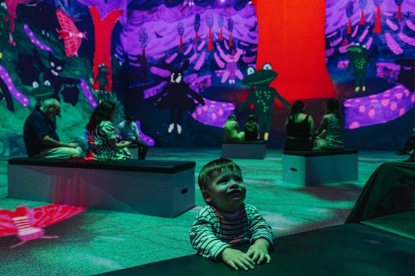 A young art fan enjoys the new Hockney exhibition at Carriageworks. 