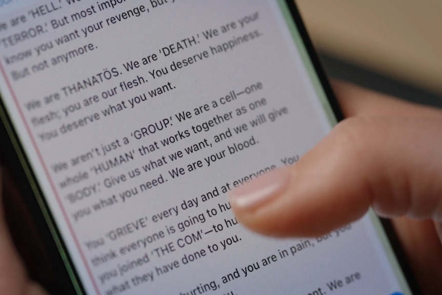A girl's hands scrolling through messages on an iPhone.